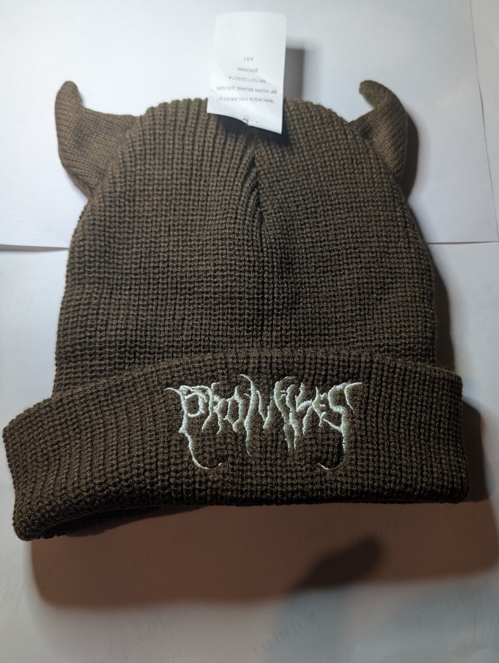 brown Broken Promises Horn Beanie featuring novelty knit devil horns and embroid